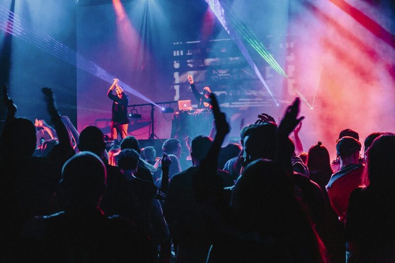 A vibrant crowd lit up at a large brand-sponsored concert in Miami