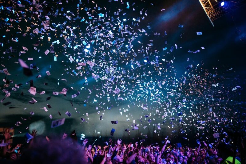 Confetti falling over a celebrating crowd at a Miami social event