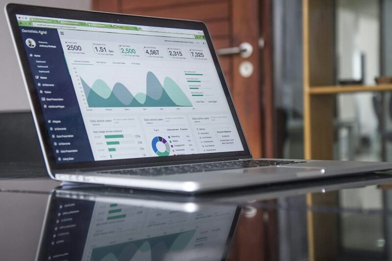 A laptop screen displaying campaign analytics and performance charts