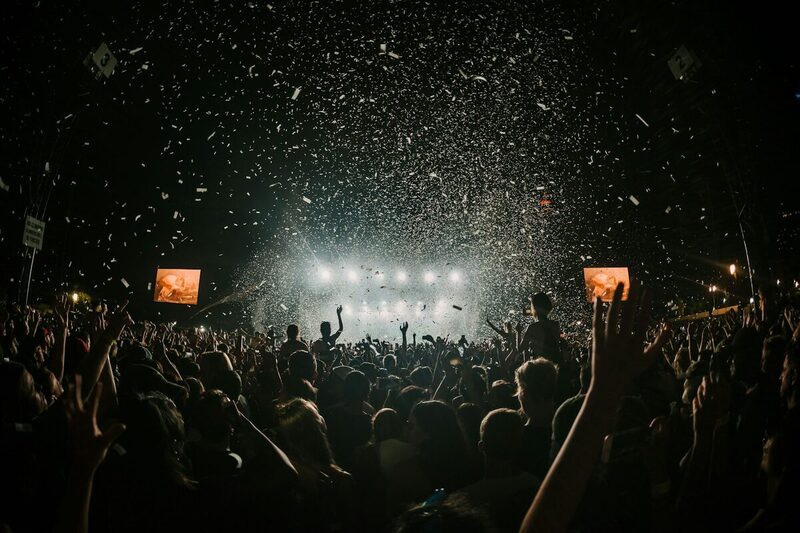 Crowd with hands raised at a sponsored music festival activation in Miami
